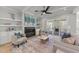 Bright living room with fireplace, built-in shelving, and access to a screened porch at 2812 Theresa Eileen Way, Raleigh, NC 27603