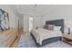 Bright main bedroom features tray ceiling, wood floors, neutral walls and a blue patterned rug at 2812 Theresa Eileen Way, Raleigh, NC 27603