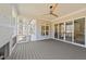 Outdoor living space on a porch with wood floors, ceiling fan, and screened windows at 2812 Theresa Eileen Way, Raleigh, NC 27603