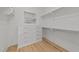 Walk-in closet with custom shelving, cabinets, drawers and hanging storage at 2812 Theresa Eileen Way, Raleigh, NC 27603