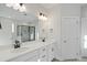 Bathroom featuring double sinks, a large mirror and a walk-in shower at 808 Challenger Ln, Knightdale, NC 27545