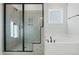 Modern bathroom featuring a gray tiled walk-in shower and a separate soaking tub at 808 Challenger Ln, Knightdale, NC 27545