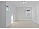 Bright bedroom featuring neutral carpeting, base trim, and a double hung window at 808 Challenger Ln, Knightdale, NC 27545