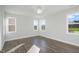 Bedroom featuring three windows that provide natural light and wood-look floors at 808 Challenger Ln, Knightdale, NC 27545