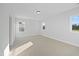 Bright bedroom featuring neutral carpeting, base trim, and double-hung windows at 808 Challenger Ln, Knightdale, NC 27545