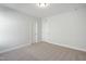 A bright bedroom featuring neutral carpeting and two doors at 808 Challenger Ln, Knightdale, NC 27545