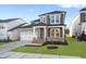 Charming two-story home features a two-car garage and a welcoming front porch with stone accents at 808 Challenger Ln, Knightdale, NC 27545