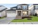 Charming two-story home features a two-car garage and a welcoming front porch with stone accents at 808 Challenger Ln, Knightdale, NC 27545