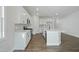 Bright open kitchen with island, stainless appliances, and sleek white cabinetry offers a modern aesthetic at 808 Challenger Ln, Knightdale, NC 27545