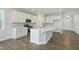Bright open kitchen with island, stainless appliances, and sleek white cabinetry offers a modern aesthetic at 808 Challenger Ln, Knightdale, NC 27545
