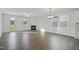 Bright living room with wood-look flooring, fireplace and views to backyard at 808 Challenger Ln, Knightdale, NC 27545