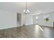Spacious living room with wood-look flooring, a ceiling fan, and a staircase at 808 Challenger Ln, Knightdale, NC 27545