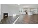 Open-concept living area featuring wood-look flooring, fireplace and kitchen with island seating at 808 Challenger Ln, Knightdale, NC 27545