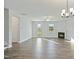 Spacious living room with wood-look floors, a ceiling fan, and a fireplace at 808 Challenger Ln, Knightdale, NC 27545
