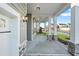 An inviting covered front porch offers a welcoming entryway with stone accents and stylish lighting at 808 Challenger Ln, Knightdale, NC 27545