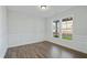 An elegantly designed room with hardwood floors and large windows allowing for natural light at 808 Challenger Ln, Knightdale, NC 27545