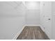 Bright walk-in closet with wire shelving and wood-look flooring ready for your custom design at 808 Challenger Ln, Knightdale, NC 27545