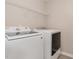 Bright laundry room, featuring washer, dryer, and shelving at 2200 Becketts Ridge Dr, Hillsborough, NC 27278