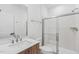 Bathroom with single vanity, wood cabinets, quartz countertop, and shower at 448 Billingshurst Way, Knightdale, NC 27545