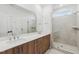 Bathroom with double vanity, wood cabinets, quartz countertop, and a shower at 448 Billingshurst Way, Knightdale, NC 27545