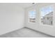 Bright bedroom featuring grey carpet and two large windows at 448 Billingshurst Way, Knightdale, NC 27545