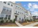 Modern townhome exterior boasts gray and white siding, stone accents, and landscaping at 448 Billingshurst Way, Knightdale, NC 27545