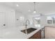 Kitchen island with quartz countertop and stainless steel sink and faucet at 448 Billingshurst Way, Knightdale, NC 27545