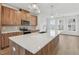 Modern kitchen features wood cabinets, quartz countertops, and stainless steel appliances at 448 Billingshurst Way, Knightdale, NC 27545