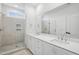 Bathroom with a walk-in shower and double sink vanity with white cabinets at 506 Billingshurst Way, Knightdale, NC 27545