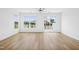 Spacious bedroom with light hardwood floors, lots of natural light, and sliding door to porch at 506 Billingshurst Way, Knightdale, NC 27545