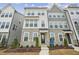 Beautifully designed three-story townhouse with stone accents and multiple windows at 506 Billingshurst Way, Knightdale, NC 27545