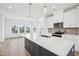 Modern kitchen features a large center island, stainless steel appliances, and hardwood floors at 506 Billingshurst Way, Knightdale, NC 27545