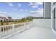 View of deck with white railing overlooking a row of evergreen trees at 506 Billingshurst Way, Knightdale, NC 27545