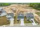 An aerial view showcases the neighborhood and highlights the blue two-story home at 8905 Stratus St, Willow Springs, NC 27592