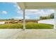 Covered back porch with a beautiful view of nature and the surrounding landscape at 8905 Stratus St, Willow Springs, NC 27592