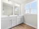 Bathroom featuring a double sink vanity, wood look floors and natural light at 8905 Stratus St, Willow Springs, NC 27592