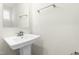 Bright bathroom featuring pedestal sink, a neutral color palette and natural light from a window at 8905 Stratus St, Willow Springs, NC 27592