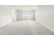 Unfinished bonus room with plush carpeting, multiple windows and neutral color palette at 8905 Stratus St, Willow Springs, NC 27592