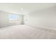 Unfinished bonus room with plush carpeting and natural light from multiple windows at 8905 Stratus St, Willow Springs, NC 27592