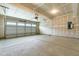 An unfinished two-car garage with windows, electrical box, and concrete flooring at 8905 Stratus St, Willow Springs, NC 27592