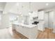 Modern kitchen with white cabinetry, quartz countertops, and stainless steel appliances at 8905 Stratus St, Willow Springs, NC 27592