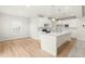Modern kitchen with white cabinetry, quartz countertops, and stainless steel appliances at 8905 Stratus St, Willow Springs, NC 27592