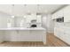 Modern kitchen with white cabinetry, quartz countertops, and stainless steel appliances at 8905 Stratus St, Willow Springs, NC 27592