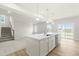 Open kitchen with a large island, modern appliances, and a view of the backyard through sliding glass doors at 8905 Stratus St, Willow Springs, NC 27592