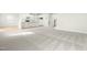 Carpeted living room showcasing white kitchen and staircase at 8905 Stratus St, Willow Springs, NC 27592