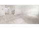 Large carpeted living room with a staircase and entryway visible in the background at 8905 Stratus St, Willow Springs, NC 27592
