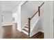 Elegant staircase with wooden steps and a white railing, leading to the upper level at 1005 Bostonian Dr, Knightdale, NC 27545