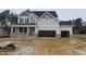 Two-story house with stone accents and a two-car garage at 5008 Trotter Dr, Raleigh, NC 27603