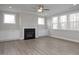 Bright living room featuring a cozy fireplace, built-in cabinets, and lots of windows at 5008 Trotter Dr, Raleigh, NC 27603