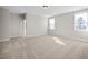 Bright bedroom with carpeted floor and multiple windows at 5017 Trotter Dr, Raleigh, NC 27603